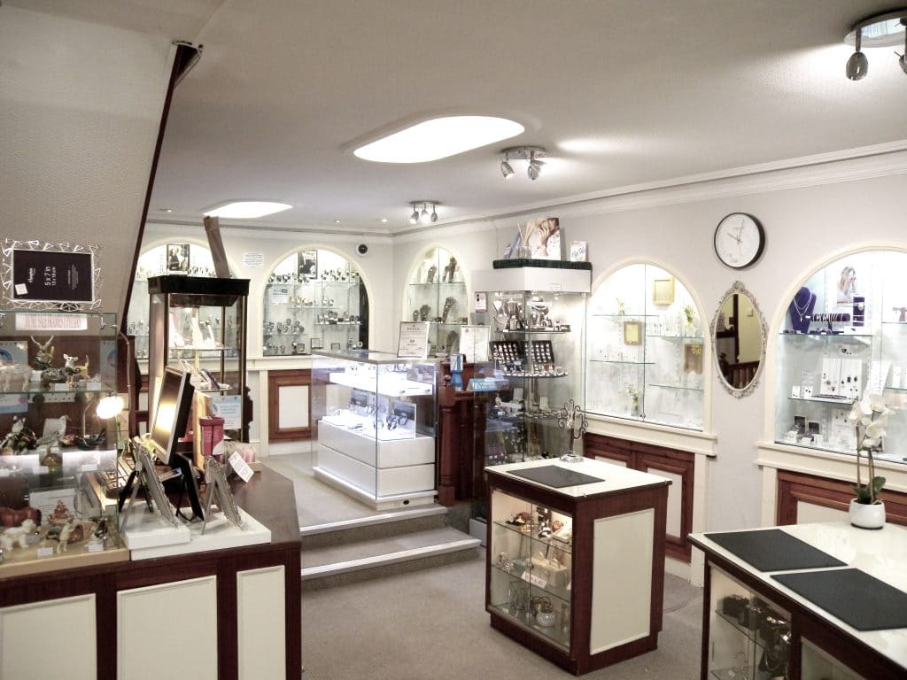 Interior of the Charles Hart shop with cabinets of antique rings and watches